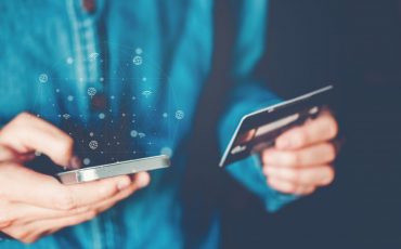 Online banking businessman using smartphone with credit card Fin