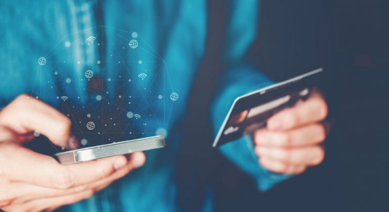 Online banking businessman using smartphone with credit card Fin
